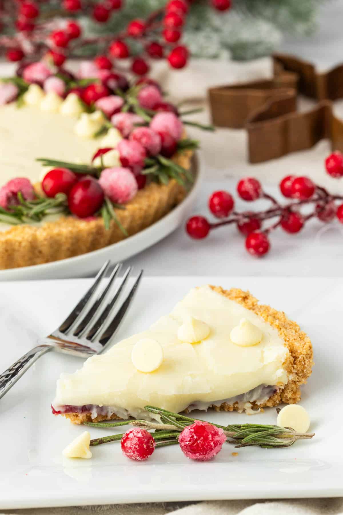 A slice of cranberry tart on a white serving plate.
