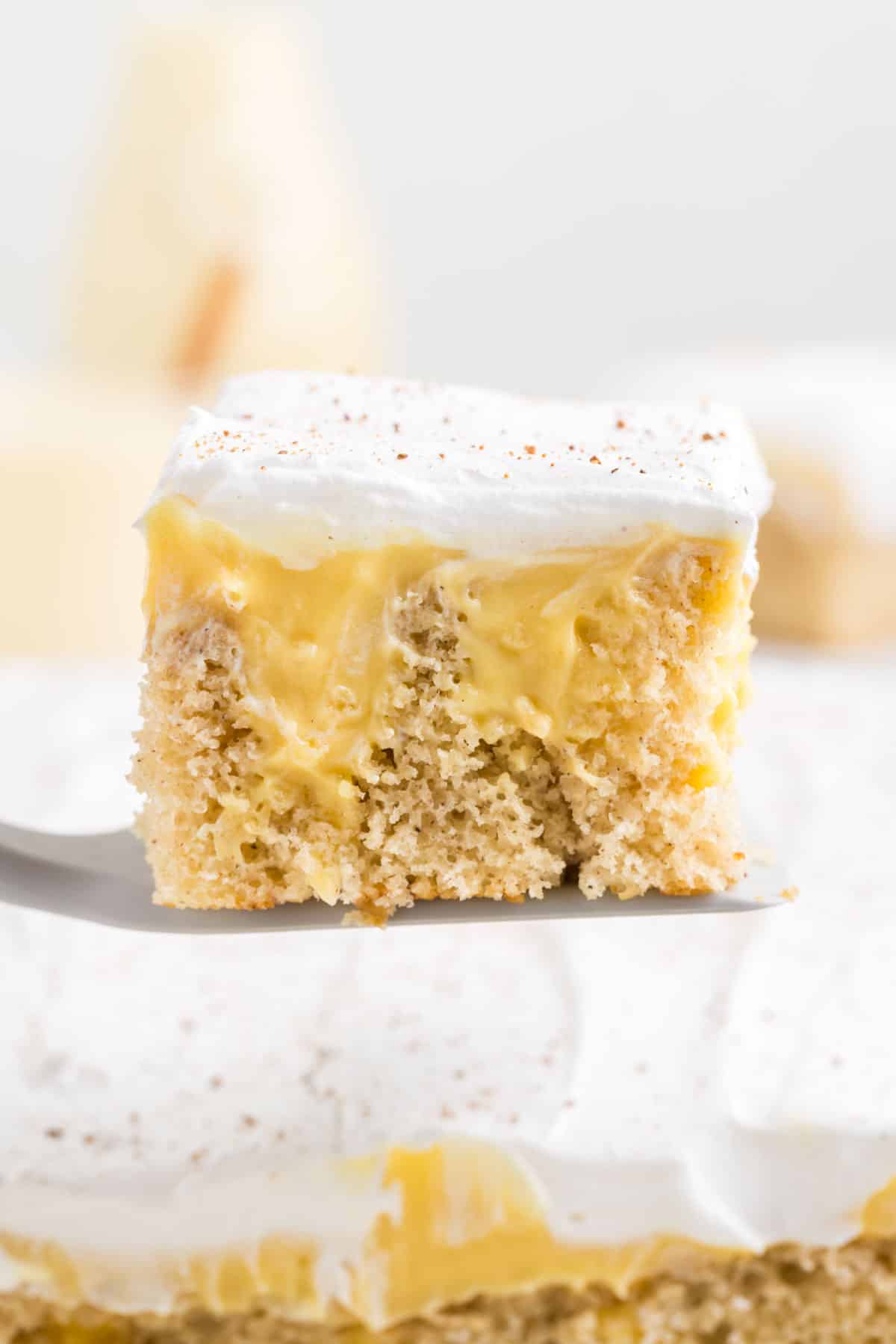 A lice of cake being served with a spatula.