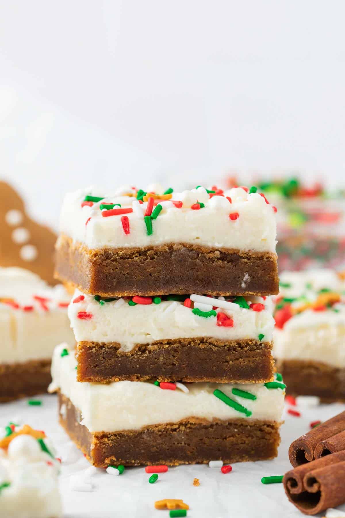 Three sliced gingerbread cookie bars decorated with sprinkles stacked on top of each other.