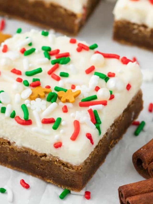 Gingerbread Cookie Bars , frosted and topped with red and green sprinkles.