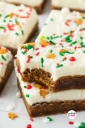 Two gingerbread cookie bars stacke dand one has a bite taken.