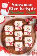 Snowman rice krispie treat for Christmas on a wooden platter ready to be served.