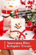 A snowman rice krispie treat standing up and a cookie jar in the background.