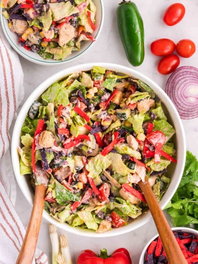 A Tex-Mex Chicken Chopped Salad tossed in creamy lime dressing in a white bowl.