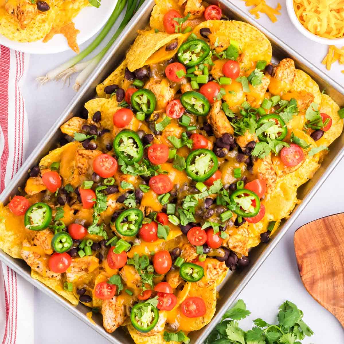 Easy loaded chicken nachos on a sheet pan.