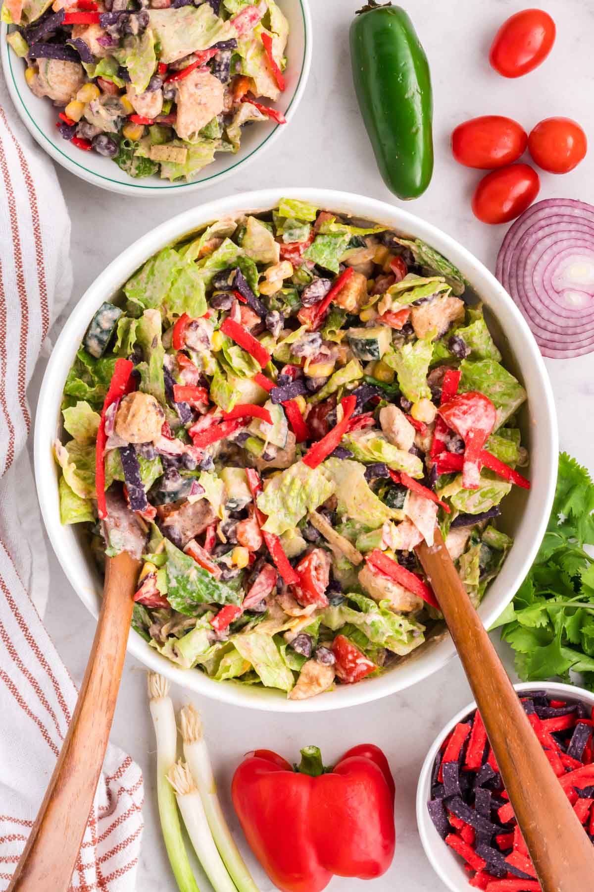 A Tex-Mex Chicken Chopped Salad tossed in creamy lime dressing in a white bowl.