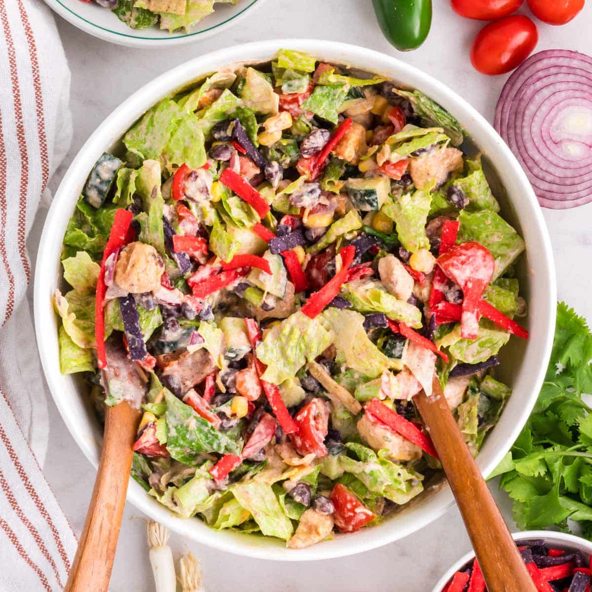 A Tex-Mex Chicken Chopped Salad tossed in creamy lime dressing in a white bowl.