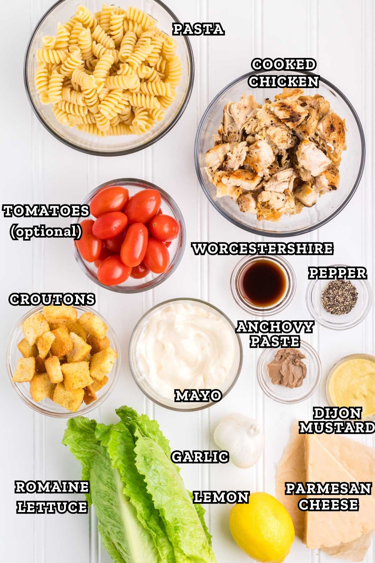 Labeled image of ingredients needed to chicken caesar pasta salad recipe.