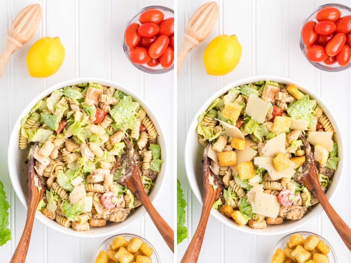 A white bowl with chicken caesar pasta salad tossed with wooden spoons and then topped with shaved parmesan cheese and croutons.