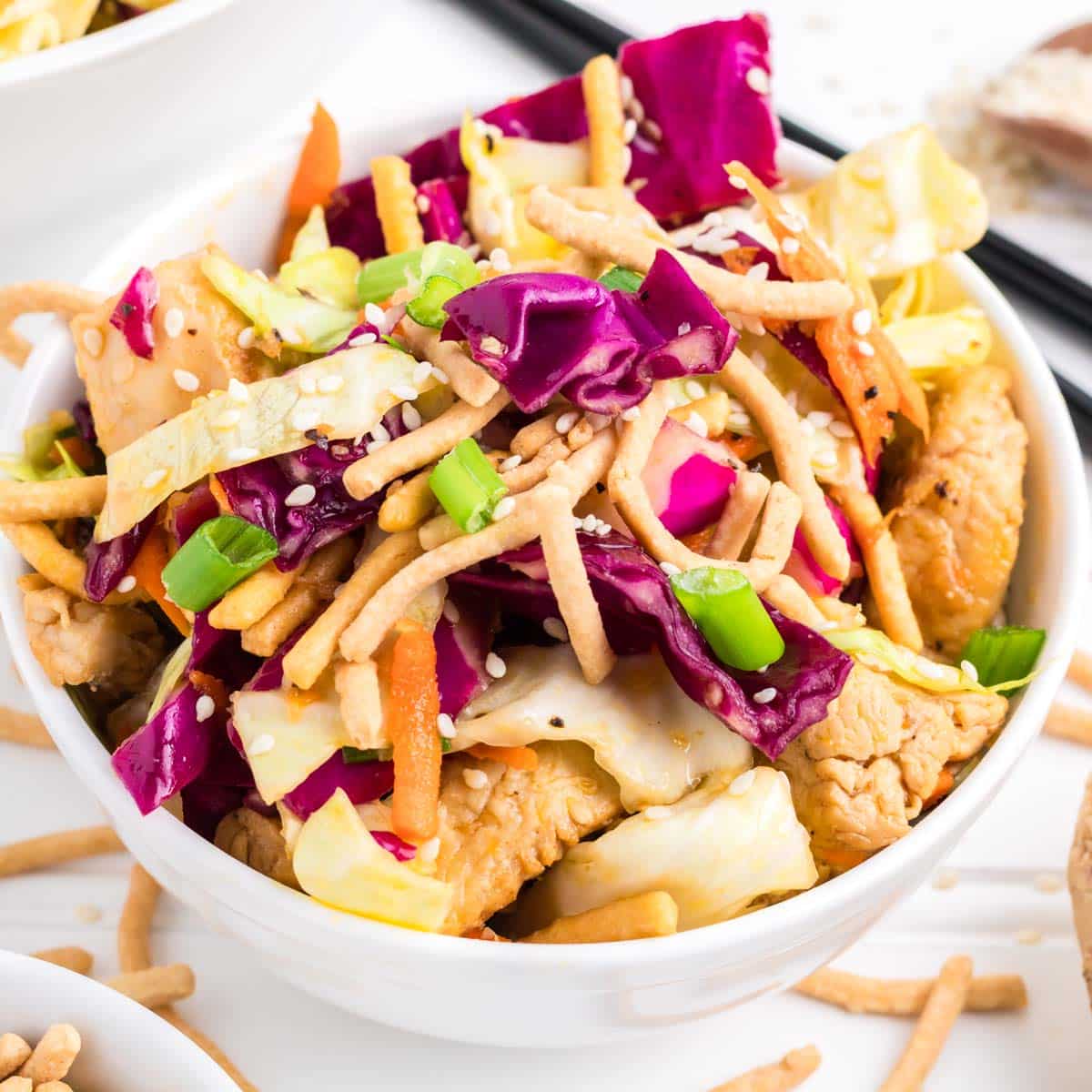 A bowl of Chinese Chicken Salad in a white bowl.