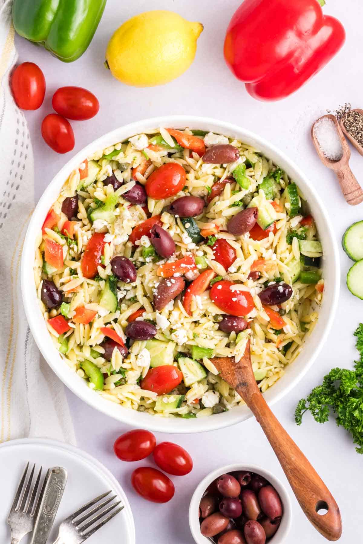 A white bowl filled with Mediterranean Orzo Pasta salad.