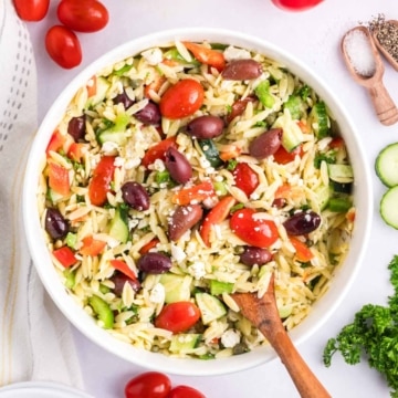 A white bowl filled with Mediterranean Orzo Pasta salad.