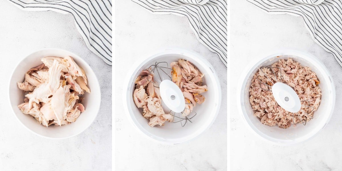 Cooked chicken added to a stand mixer and shredded.