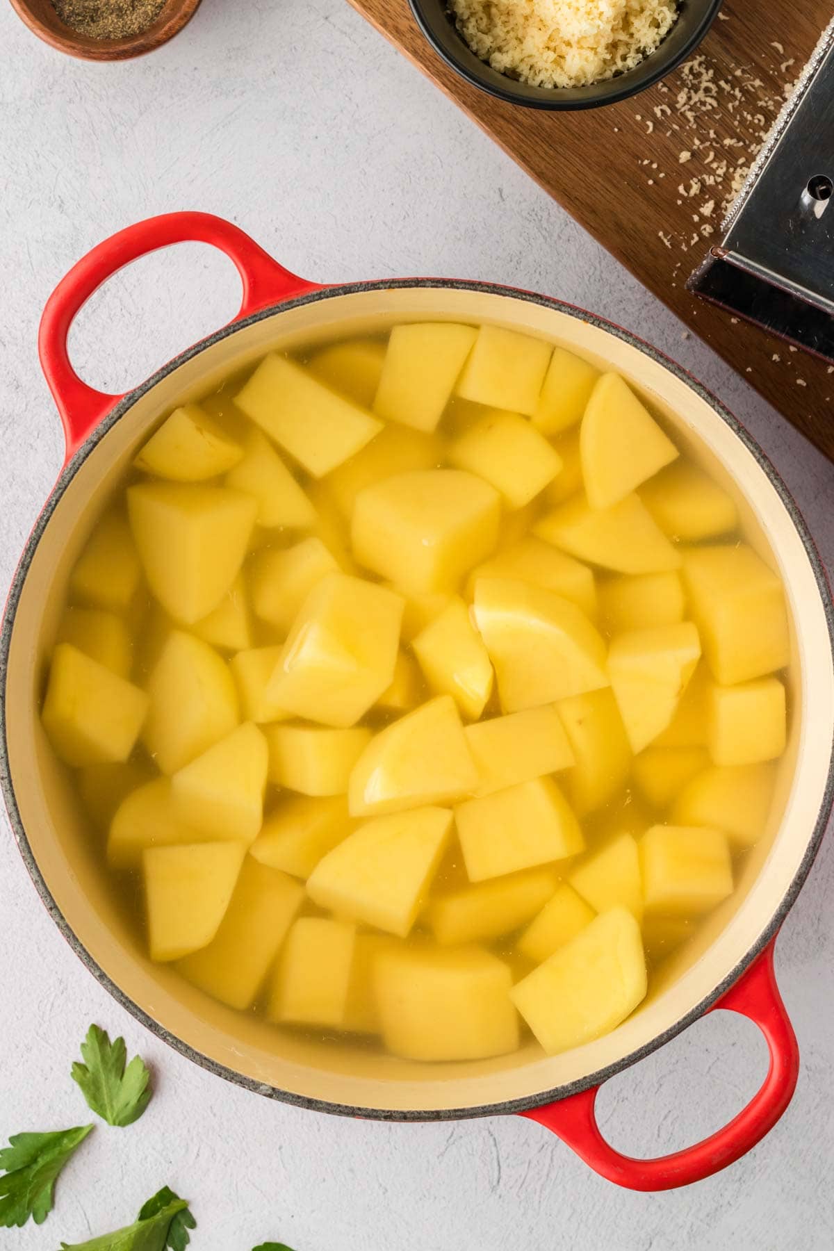 Cut potatoes in a pot covered with water.