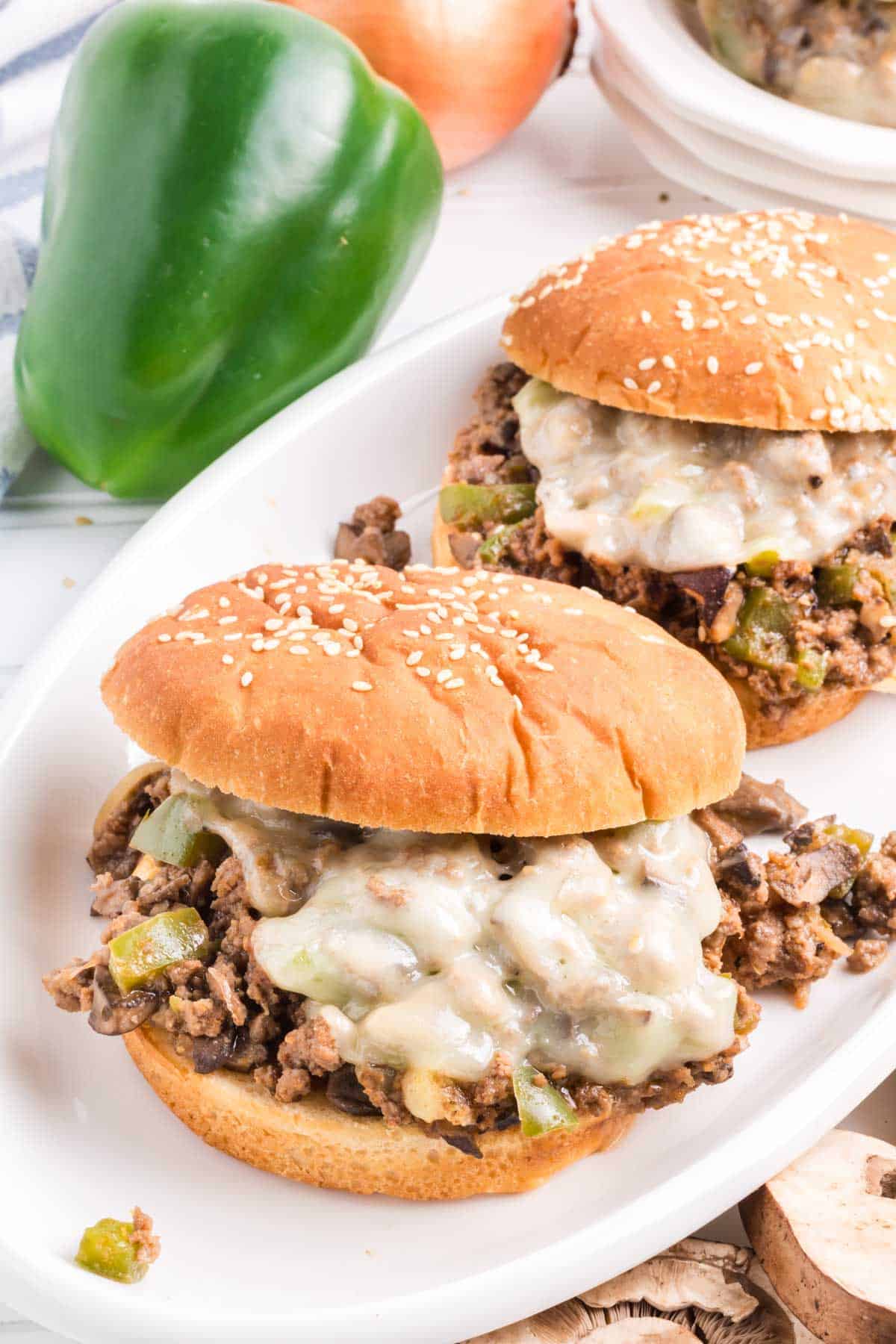 Beef cheesesteak sloppy joes on a white plate.