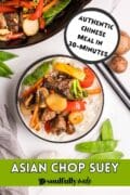 Asian Chop Suey recipe made with beef is centerred with veggies, chop sticks and the pan surrounding.
