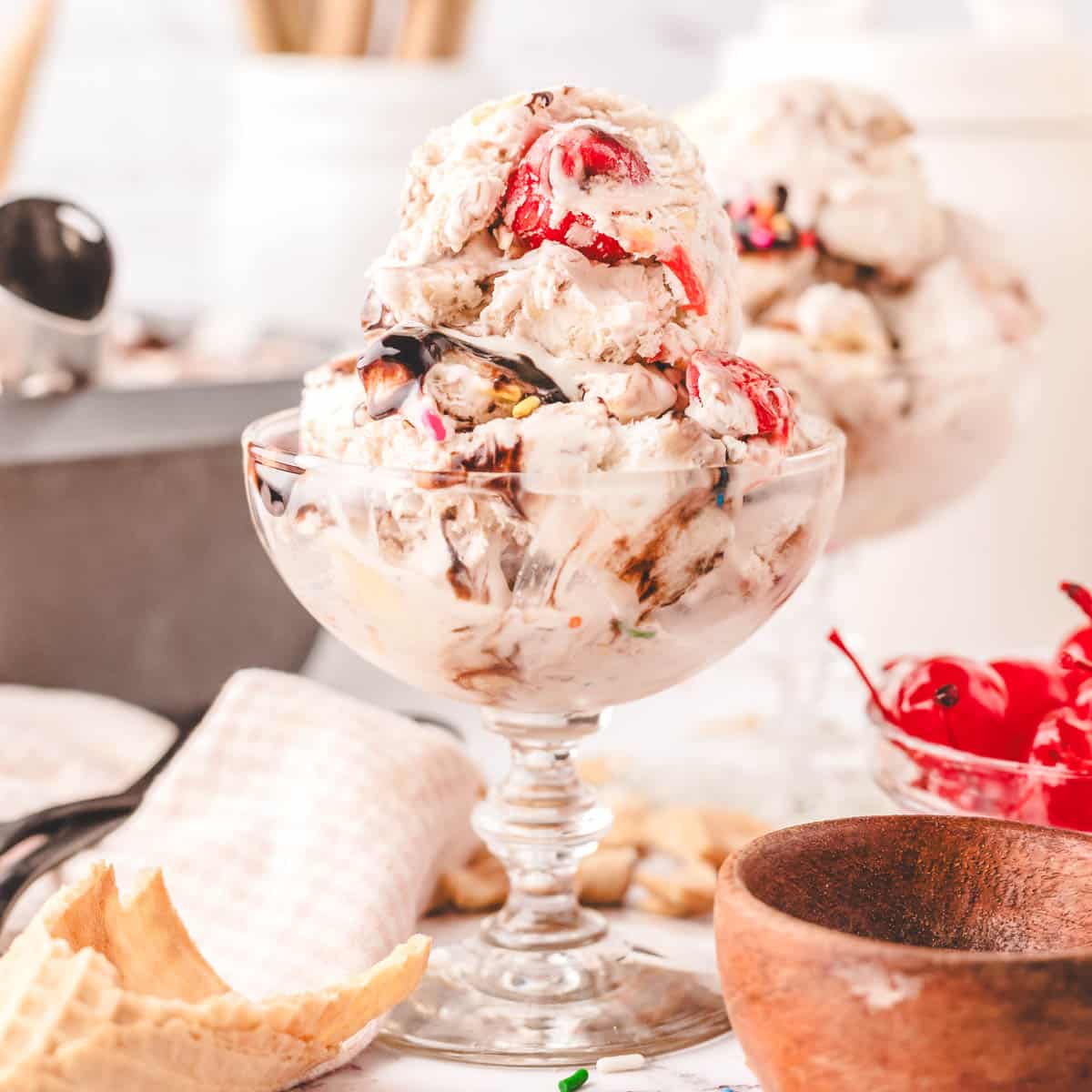 A glass dessert bowl with scoops of no-churn banana slip ice cream.