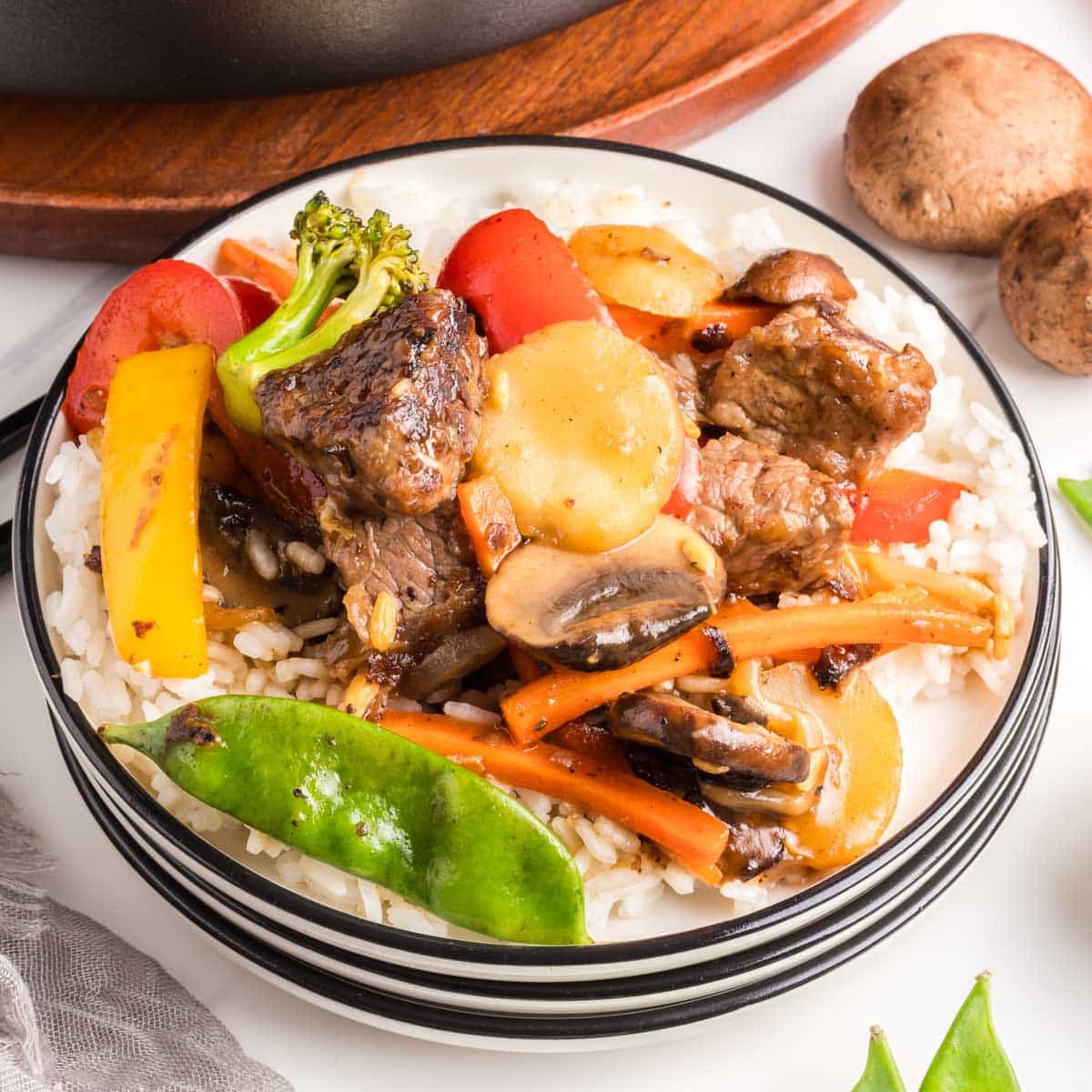 Beef Chopped Suey on a white plate with a black rim.