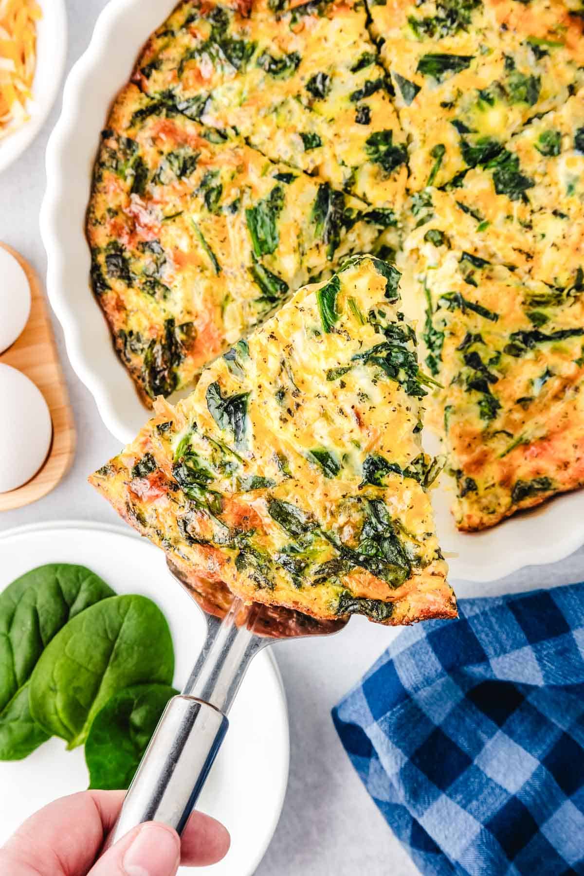 Spinach quiche on a spatula.