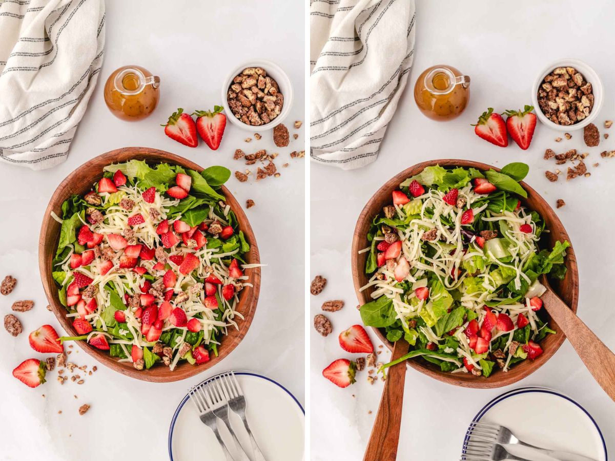 A wooden bowl filled with strawberry salad ingredients and then tossed with wooden tongs.