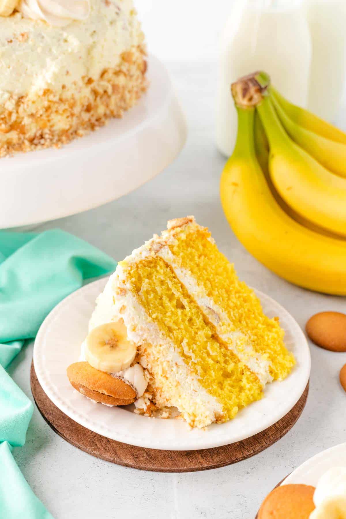 A slice of banana pudding cake on a white plate.