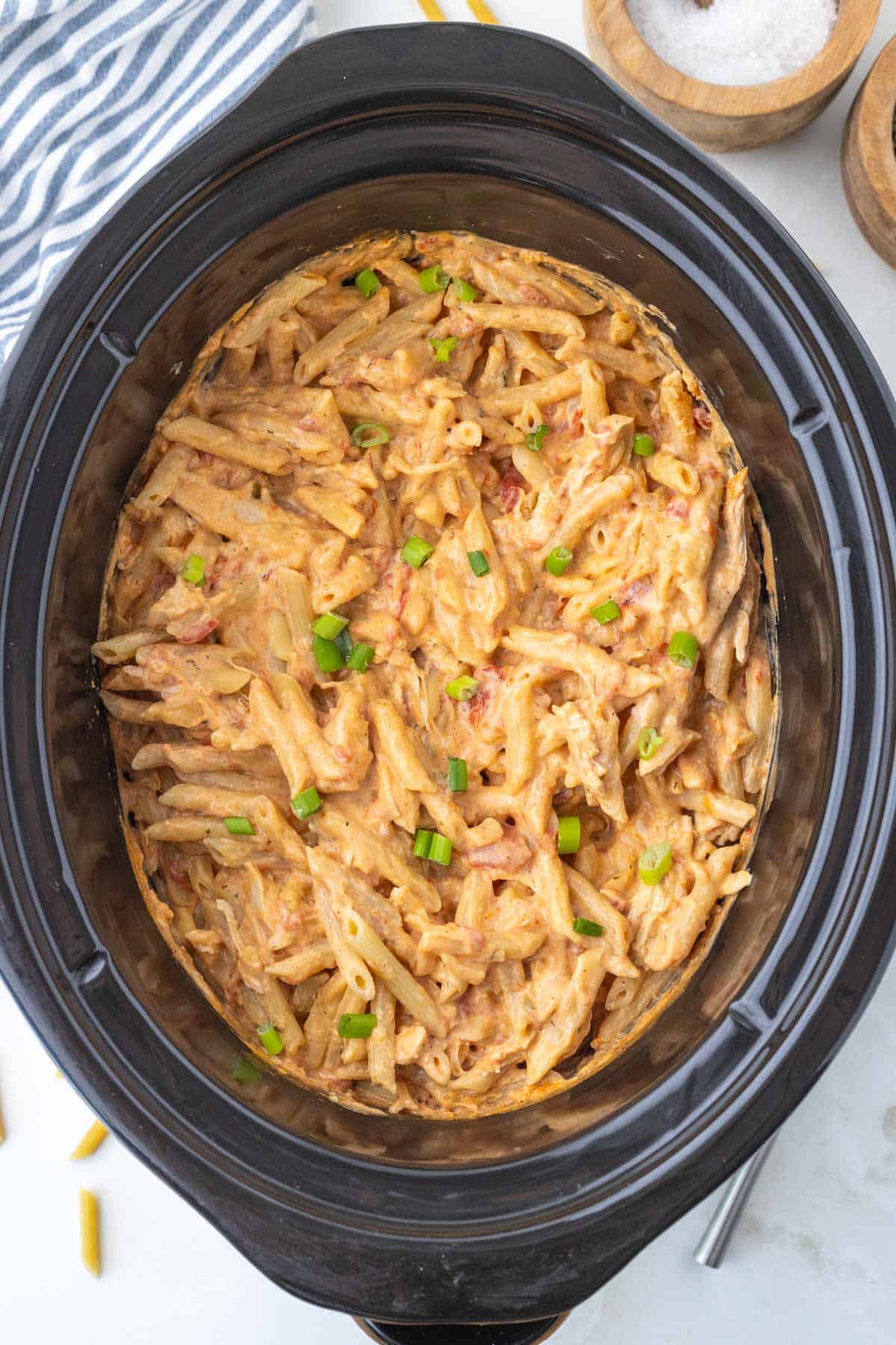A crock pot filled with creamy buffalo chicken pasta.