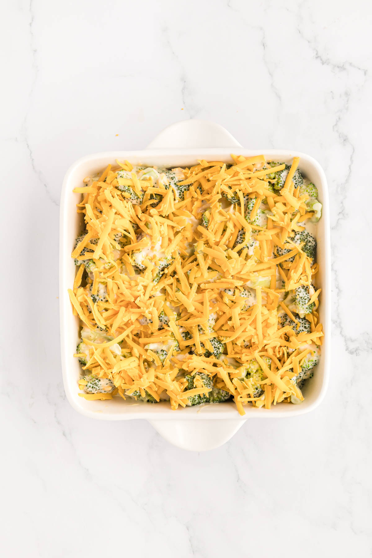 Shredded cheese sprinkled on top of the casserole before baking.