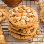 Four cookies stacked on top of each other on top of a cooling rack.
