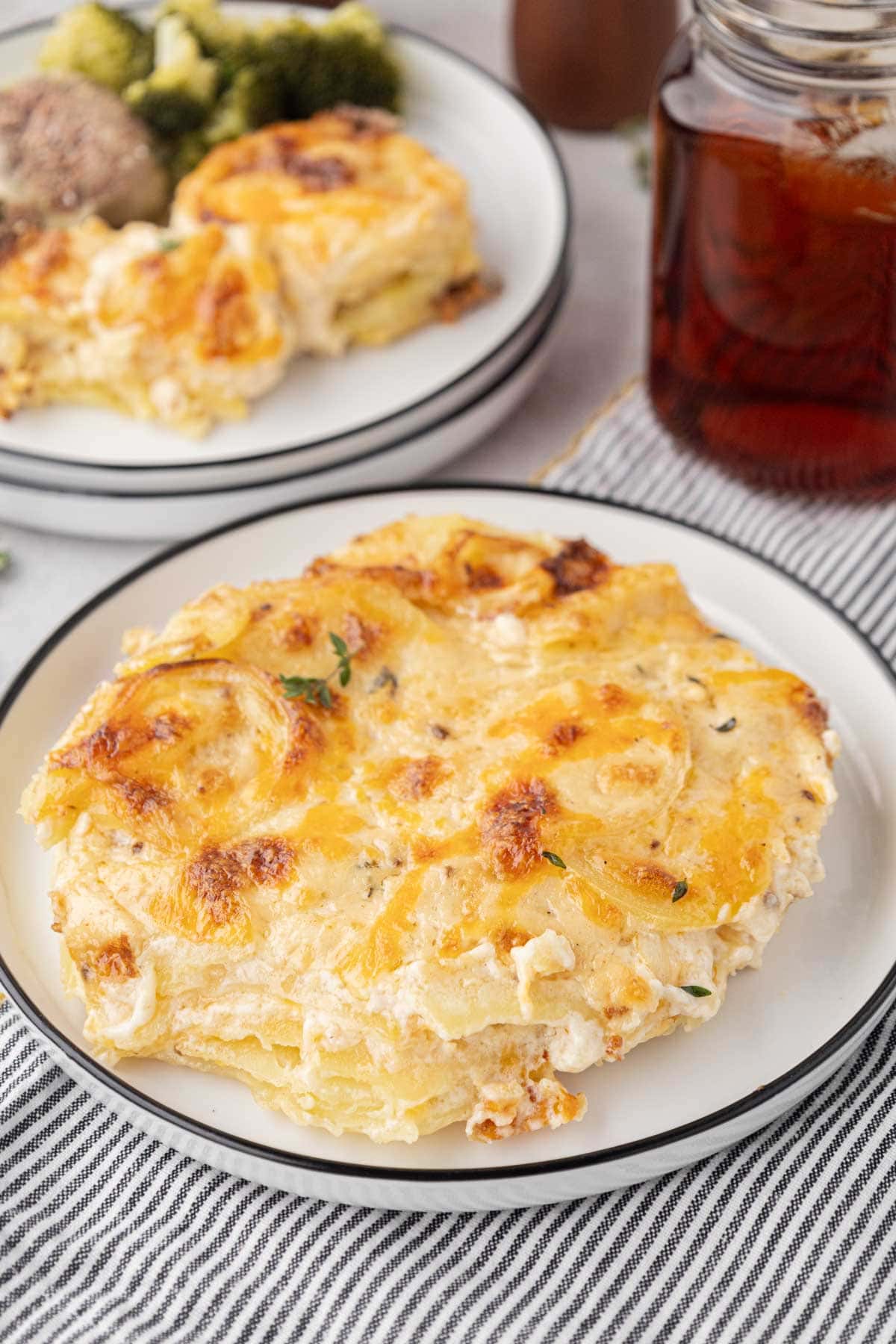 Plate served with cheesy scallop potatoes on it.