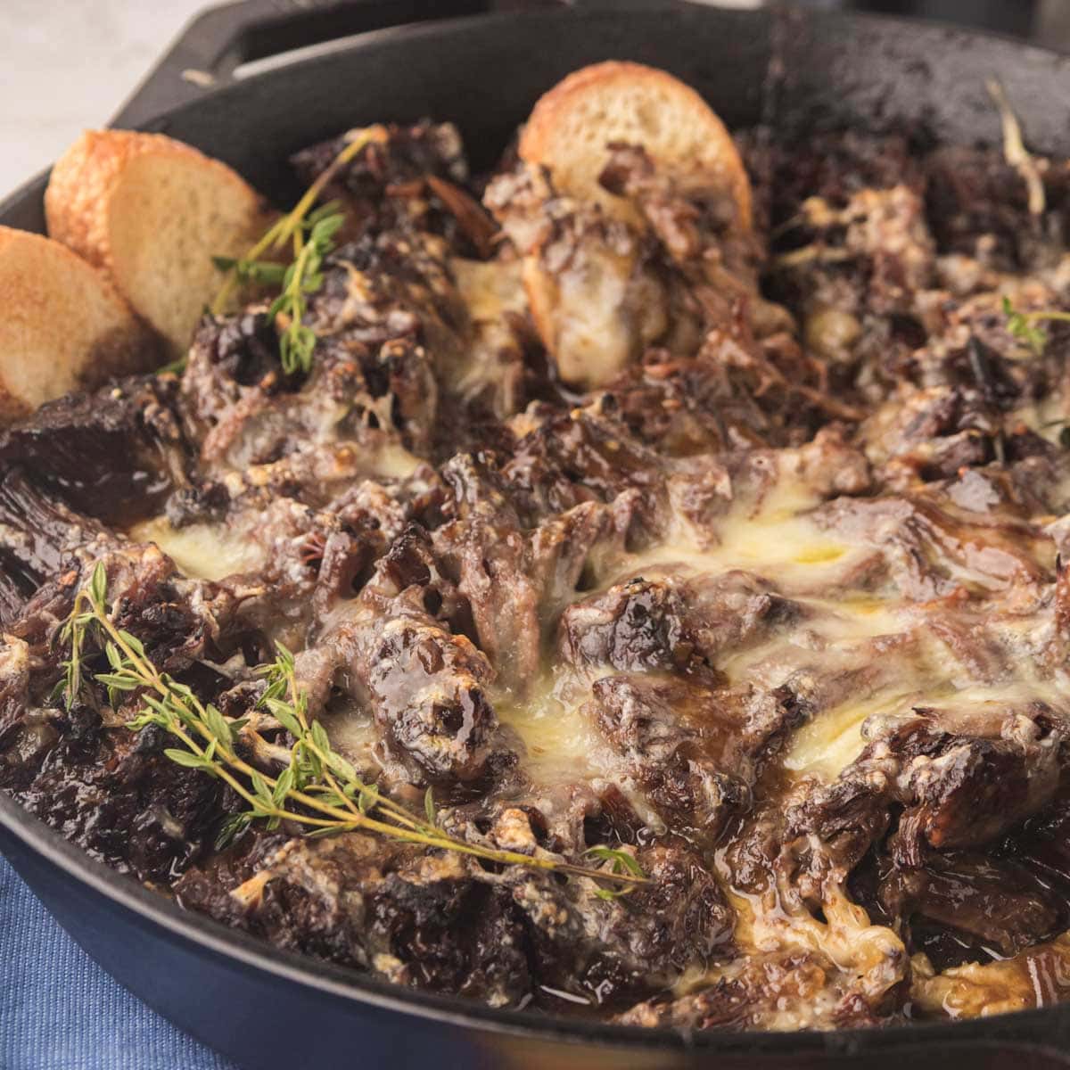 The cast-iron skillet filled with roast beef made with French onion soup mix.