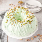 Pistachio bundt cake on a cake pedestal.
