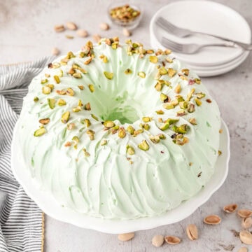 Pistachio bundt cake on a cake pedestal.