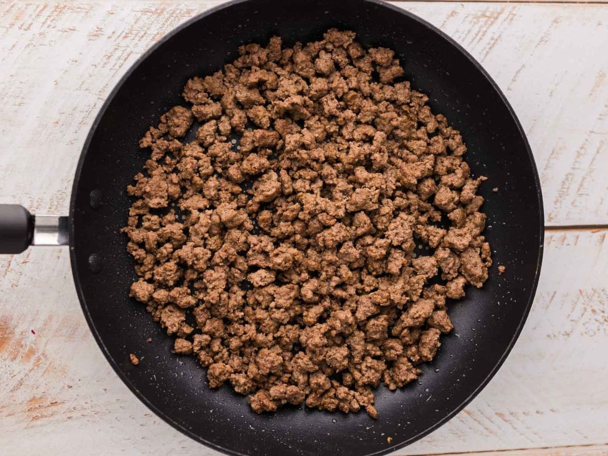 Ground beef browned in a skillet.