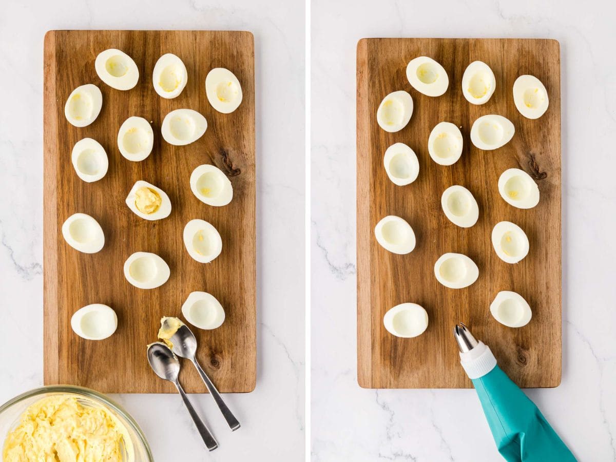Boiled egg whites that have been half on a wooden board with deviled egg filling being spooned and piped on.