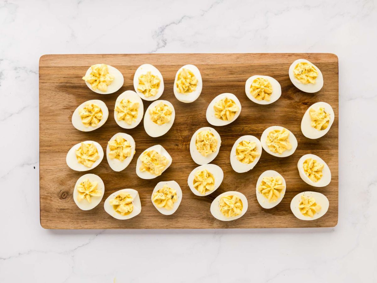 Piped filling into halved boiled eggs.
