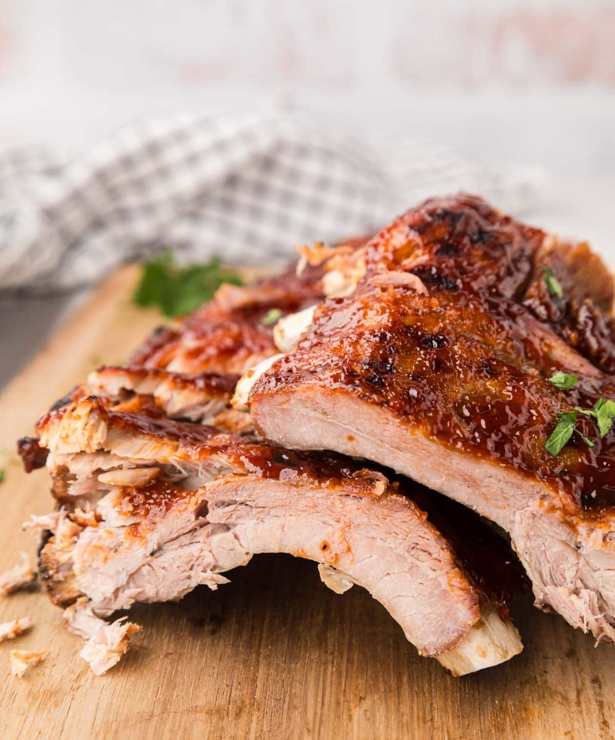Cut BBQ ribs on a wooden board.