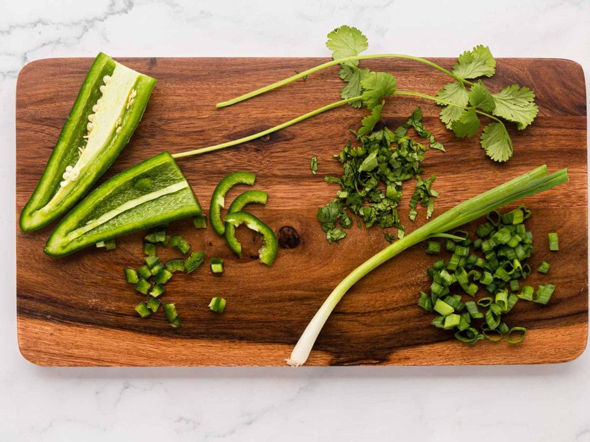 Veggies, diced on a wood color board.