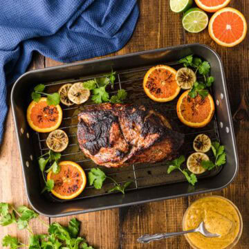 Overhead shot of roasted Cuban pork on a roasting pan.
