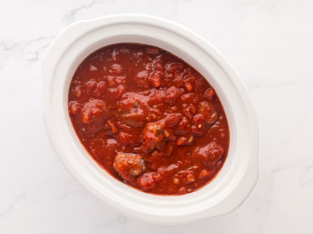 Overhead shot of slow cooker Italian meatballs and sauce in a crock pot.