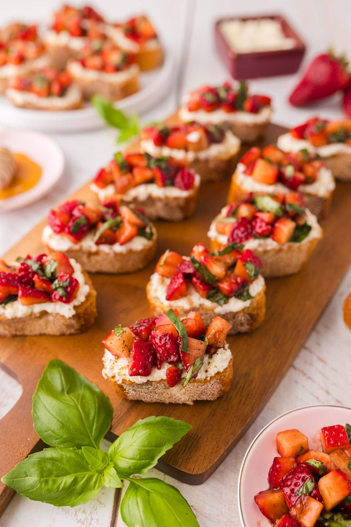 Strawberry bruschetta served on a wooden board.