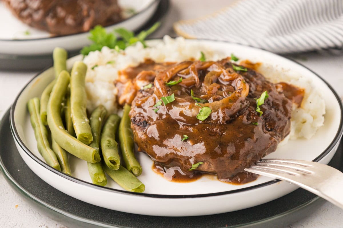 Hamburger steak over mashed potatoes.