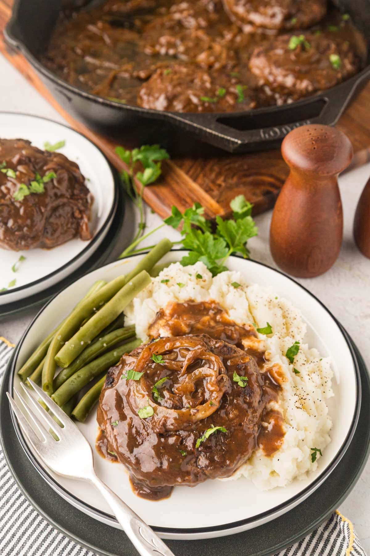 Hamburger steak over mashed potatoes.