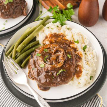Hamburger steak and gravy over mashed potatoes.