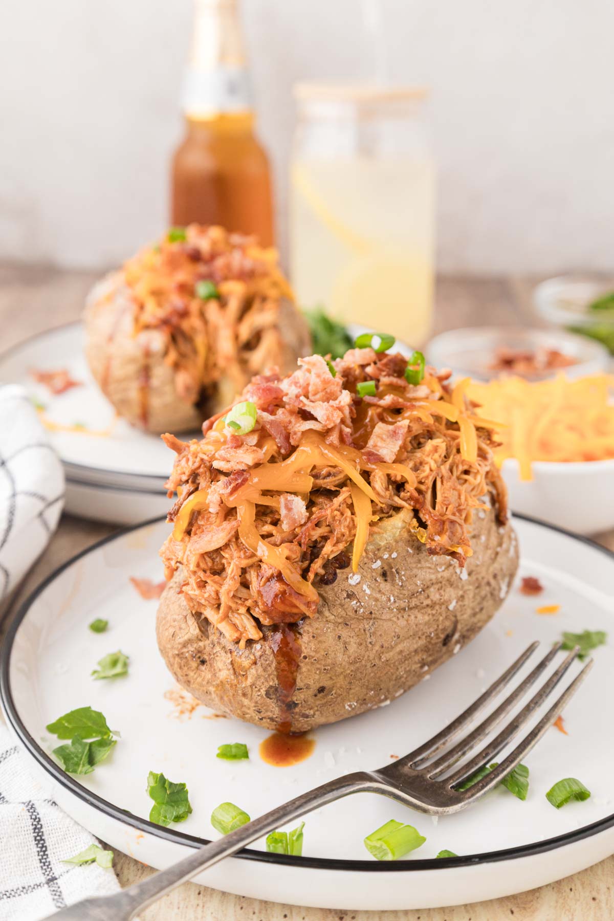Loaded BBQ Pulled Chicken Baked potato on a plate.