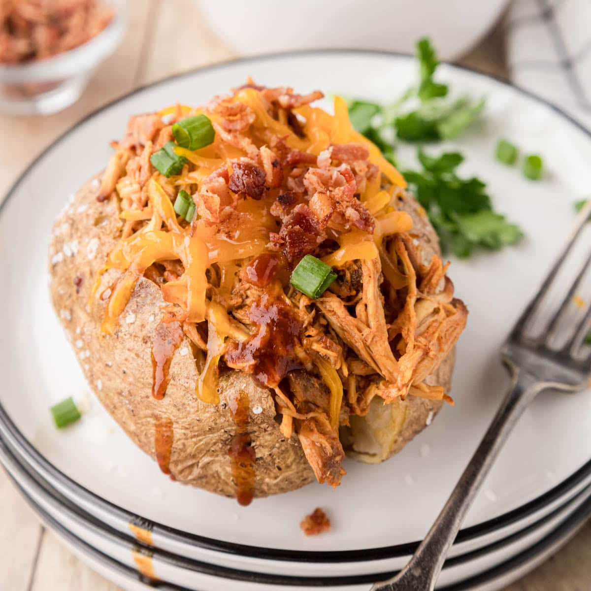 A loaded baked potato stuffed with slow cooker, pulled chicken.