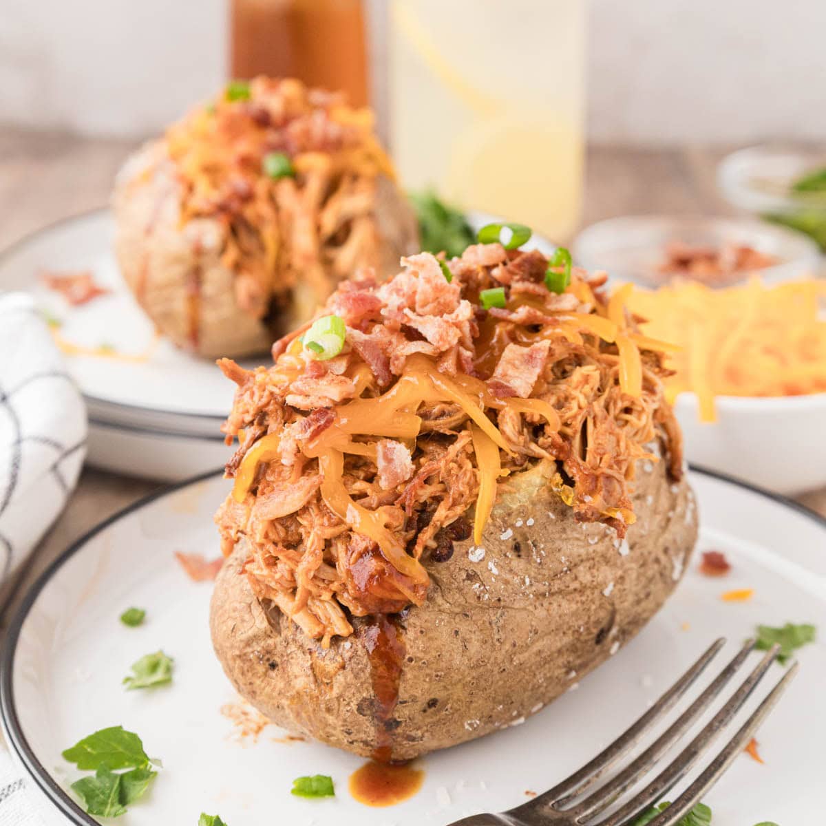 A loaded barbecue baked potato drizzled with barbecue sauce.