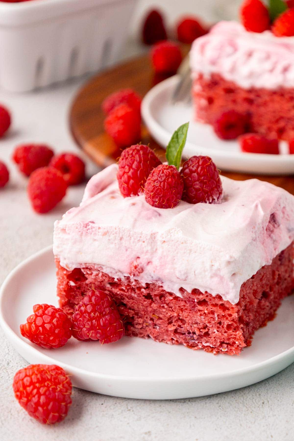Slice of raspberry fluff cake garnished with mint.