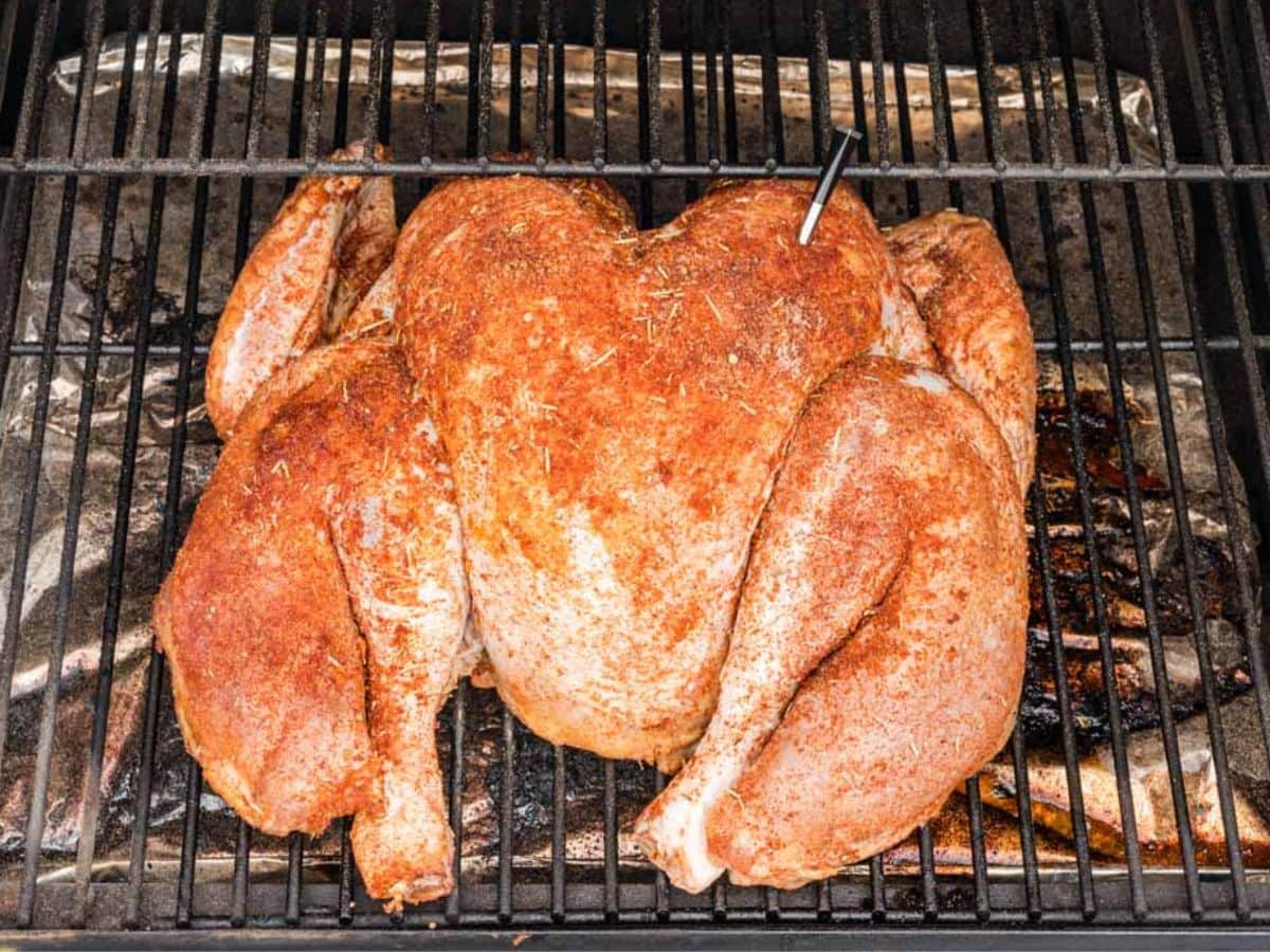 Spatchcocked turkey on the grill to cook.