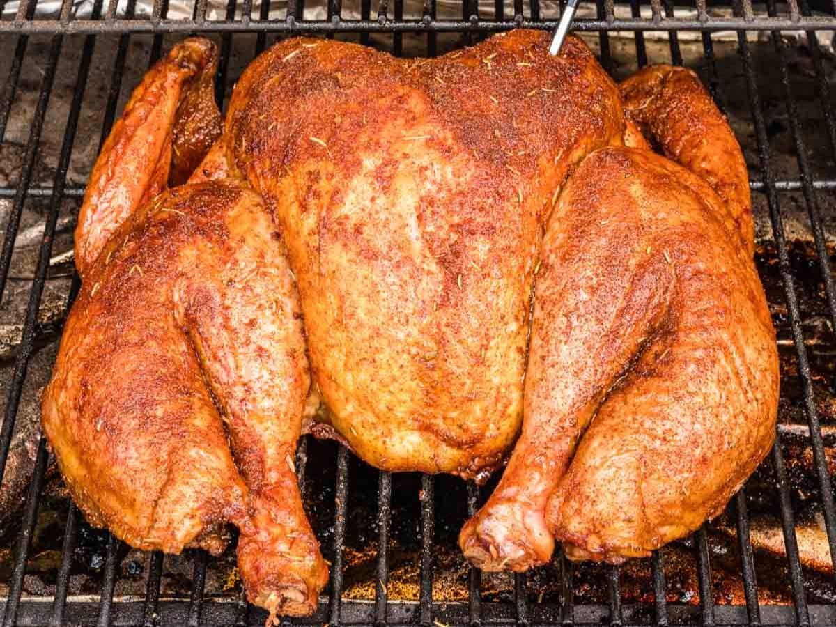 Smoked spatchcock turkey on the grill grates after cooking.
