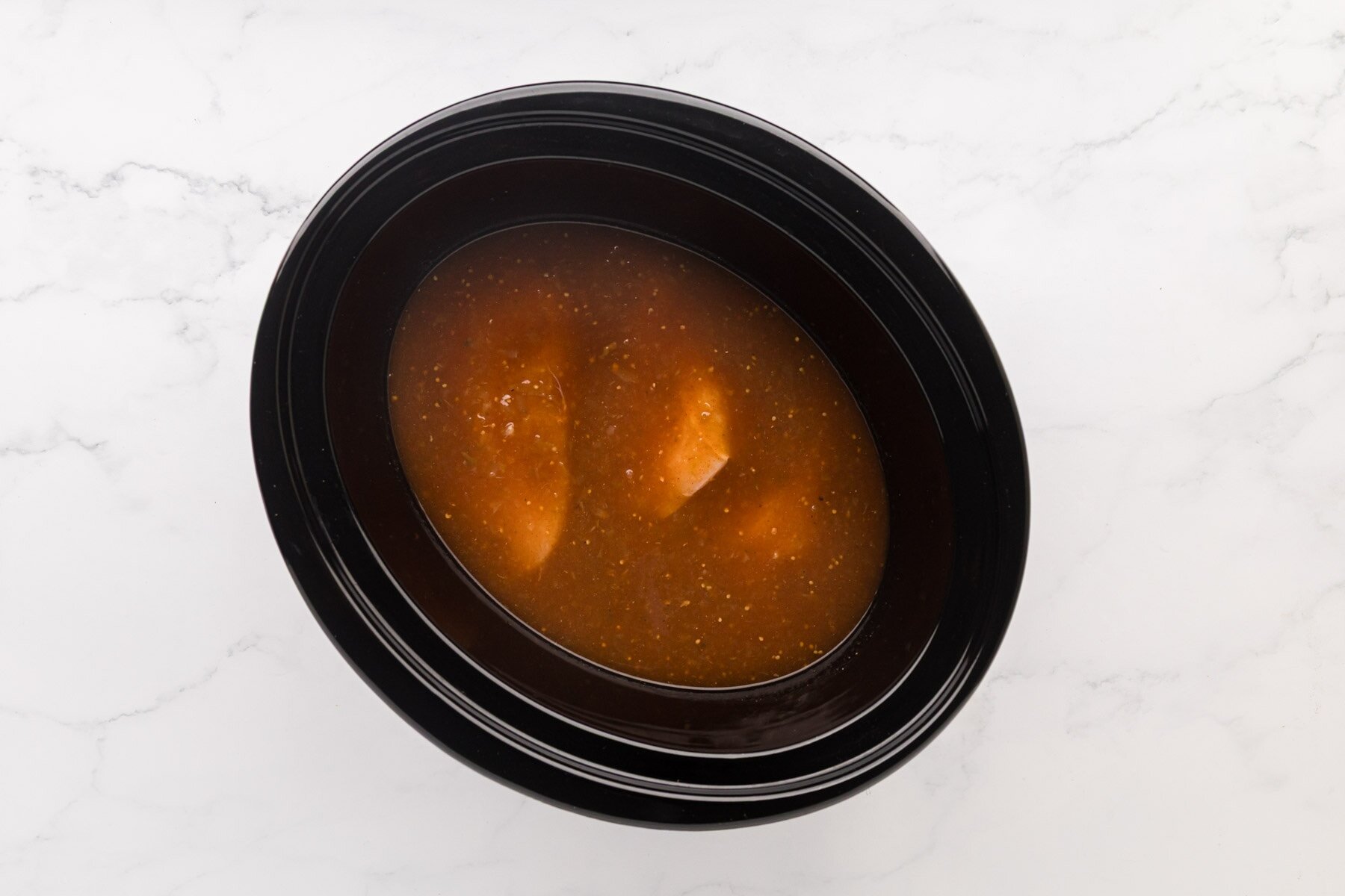Sauce covering chicken breasts.